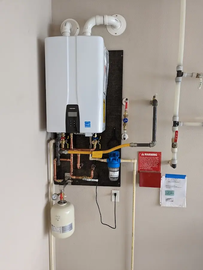 Professional plumber installing copper piping in a North Kingstown home